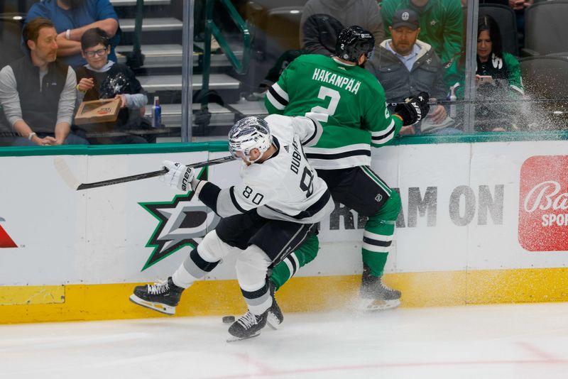 Mar 16, 2024; Dallas, Texas, USA; Los Angeles Kings center Pierre-Luc Dubois (80) and Dallas Stars defenseman Chris Tanev (3) bang into the boards during the first period at American Airlines Center. Mandatory Credit: Andrew Dieb-USA TODAY Sports