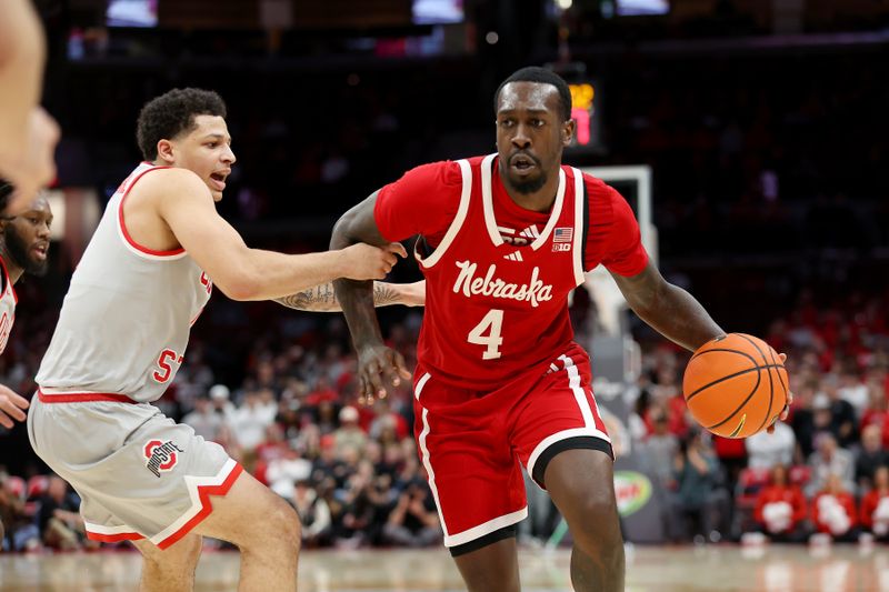 Mar 4, 2025; Columbus, Ohio, USA;  Nebraska Cornhuskers forward Juwan Gary (4) dribbles the ball as Ohio State Buckeyes guard John Mobley Jr. (0) defends during the first half at Value City Arena. Mandatory Credit: Joseph Maiorana-Imagn Images