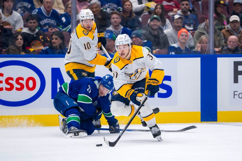 Jan 3, 2025; Vancouver, British Columbia, CAN; Nashville Predators forward Colton Sissons (10) and Vancouver Canucks forward Pius Suter (24) watch defenseman Nick Blankenburg (37) handle the puck in the first period at Rogers Arena. Mandatory Credit: Bob Frid-Imagn Images