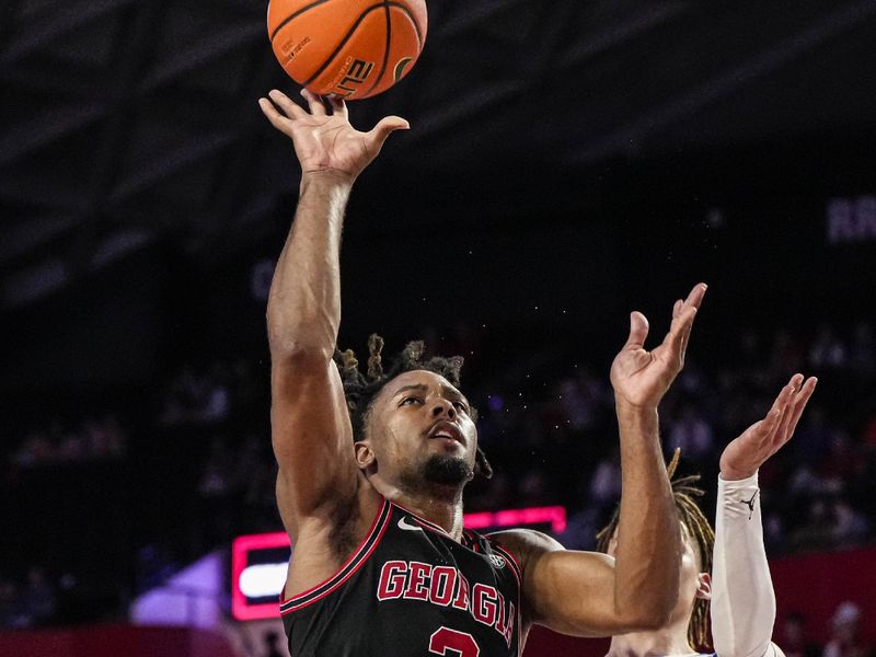 Feb 28, 2023; Athens, Georgia, USA; Georgia Bulldogs guard Kario Oquendo (3) shoots while being fouled against the Florida Gators during the second half at Stegeman Coliseum. Mandatory Credit: Dale Zanine-USA TODAY Sports