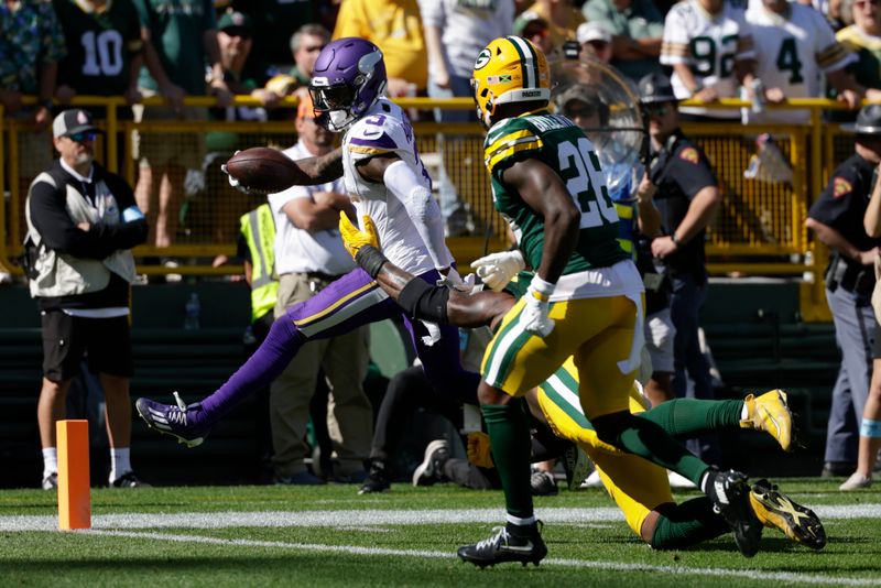 Minnesota Vikings wide receiver Jordan Addison (3) runs into the end zone for a touchdown against the Green Bay Packers defenders during the first half of an NFL football game Sunday, Sept. 29, 2024, in Green Bay, Wis. (AP Photo/Matt Ludtke)