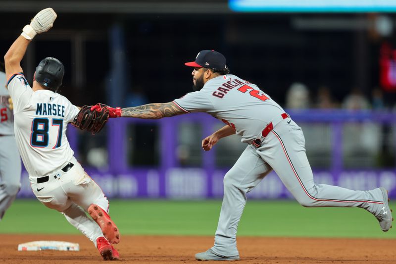 Sep 10, 2025; Miami, Florida, USA; Washington Nationals second baseman Luis Garcia Jr. (2) cannot tag Miami Marlins center fielder Jakob Marsee (87) during the sixth inning at loanDepot Park. Mandatory Credit: Sam Navarro-Imagn Images