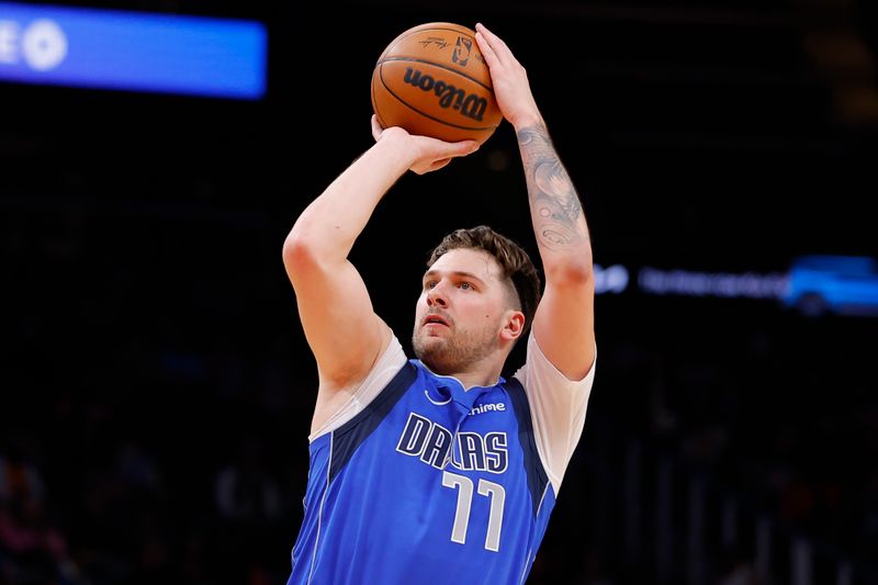 ATLANTA, GEORGIA - JANUARY 26: Luka Doncic #77 of the Dallas Mavericks shoots during the first quarter against the Atlanta Hawks at State Farm Arena on January 26, 2024 in Atlanta, Georgia. NOTE TO USER: User expressly acknowledges and agrees that, by downloading and or using this photograph, User is consenting to the terms and conditions of the Getty Images License Agreement. (Photo by Todd Kirkland/Getty Images)