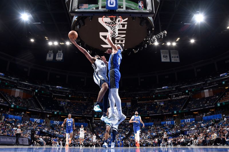 ORLANDO, FL - MARCH 30: Jordan Goodwin #4 of the Memphis Grizzlies drives to the basket during the game against the Orlando Magic on March 30, 2024 at the Kia Center in Orlando, Florida. NOTE TO USER: User expressly acknowledges and agrees that, by downloading and or using this photograph, User is consenting to the terms and conditions of the Getty Images License Agreement. Mandatory Copyright Notice: Copyright 2024 NBAE (Photo by Fernando Medina/NBAE via Getty Images)