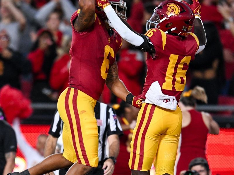 Nov 4, 2023; Los Angeles, California, USA; USC cheerleaders and fans react as USC Trojans wide receiver Tahj Washington (16) and USC Trojans running back Austin Jones (6) celebrates after scoring against the Washington Huskies during the second quarter at United Airlines Field at Los Angeles Memorial Coliseum. Mandatory Credit: Jonathan Hui-USA TODAY Sports