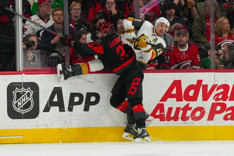 Mar 11, 2023; Raleigh, North Carolina, USA;  Carolina Hurricanes right wing Andrei Svechnikov (37) checks Vegas Golden Knights right wing Reilly Smith (19) during the second period at PNC Arena. Mandatory Credit: James Guillory-USA TODAY Sports