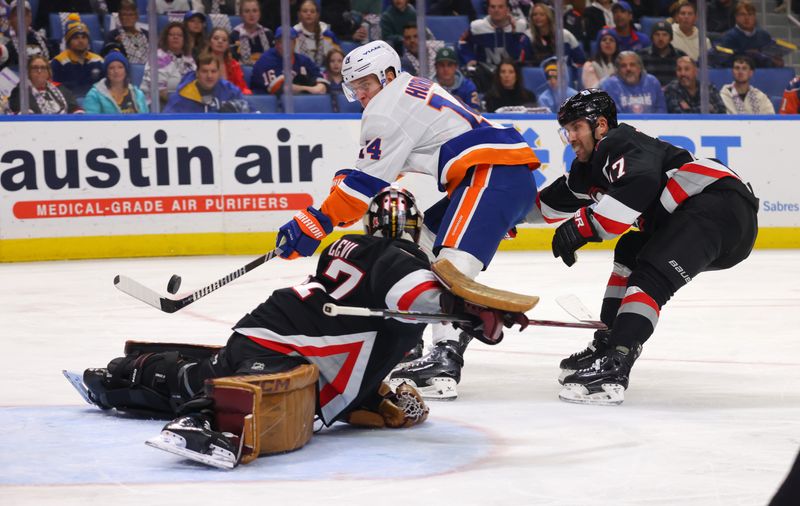 Nov 1, 2024; Buffalo, New York, USA;  New York Islanders center Bo Horvat (14) scores a goal on Buffalo Sabres goaltender Devon Levi (27) during the first period at KeyBank Center. Mandatory Credit: Timothy T. Ludwig-Imagn Images