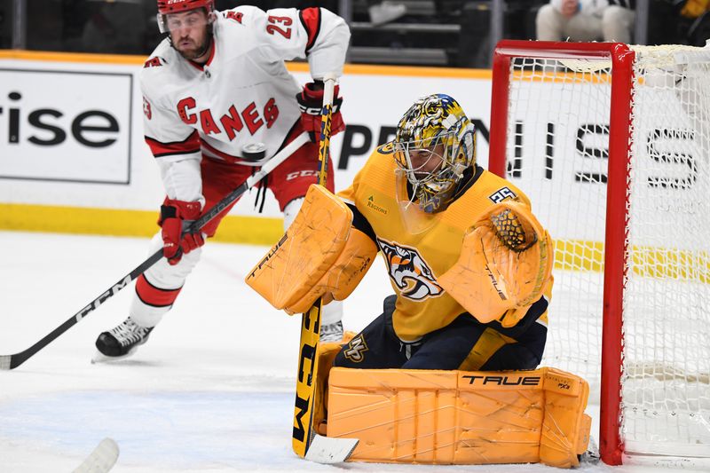 Dec 27, 2023; Nashville, Tennessee, USA; Nashville Predators goaltender Juuse Saros (74) makes a save during the second period against the Carolina Hurricanes at Bridgestone Arena. Mandatory Credit: Christopher Hanewinckel-USA TODAY Sports