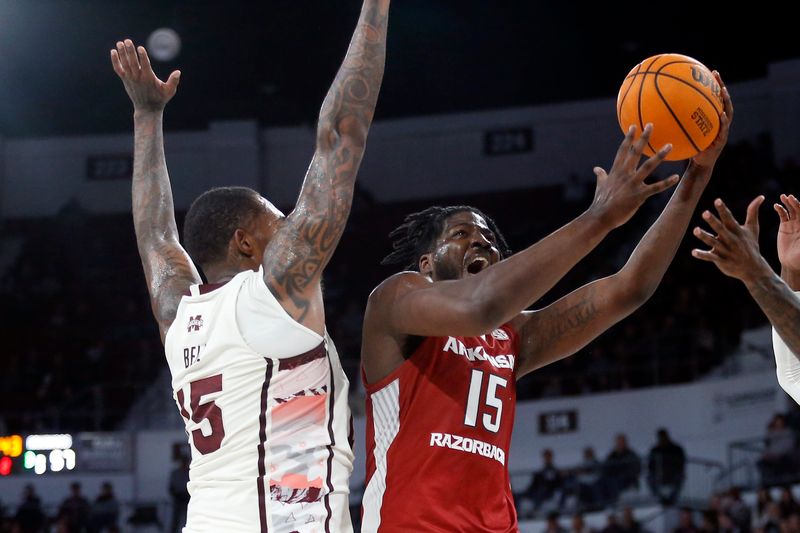 Feb 17, 2024; Starkville, Mississippi, USA; Arkansas Razorbacks forward Makhi Mitchell (15) shoots the ball against Mississippi State Bulldogs forward Jimmy Bell Jr. (15) during the second half at Humphrey Coliseum. Mandatory Credit: Petre Thomas-USA TODAY Sports