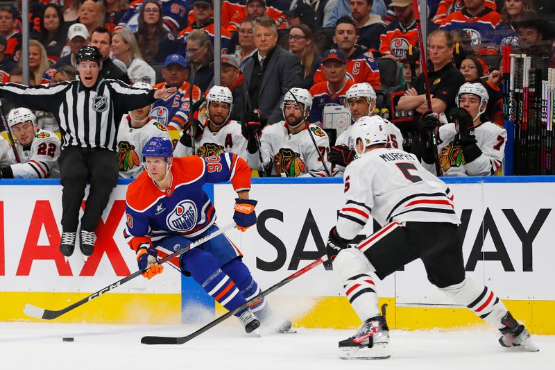 Oct 12, 2024; Edmonton, Alberta, CAN; Edmonton Oilers forward Corey Perry (90) looks to make a pass in front of Chicago Blackhawks defensemen Connor Murphy (5) during the first period at Rogers Place. Mandatory Credit: Perry Nelson-Imagn Images