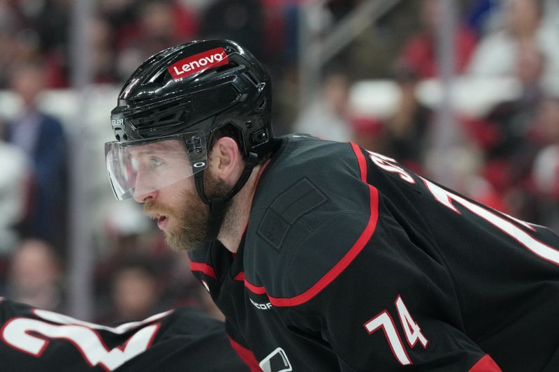 May 22, 2025; Raleigh, North Carolina, USA;  Carolina Hurricanes defenseman Jaccob Slavin (74) awaits the start of play during the second period against the Florida Panthers in game two of the Eastern Conference Final of the 2025 Stanley Cup Playoffs at Lenovo Center. Mandatory Credit: James Guillory-Imagn Images