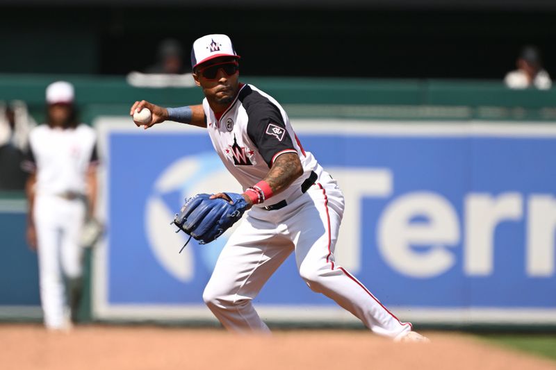 Sep 15, 2024; Washington, District of Columbia, USA; Washington Nationals shortstop Nasim Nunez (26) prepares to throw to first base against the Miami Marlins during the third inning at Nationals Park. Mandatory Credit: Rafael Suanes-Imagn Images