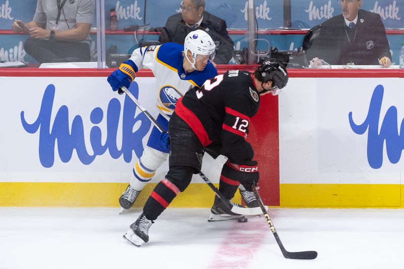 Sep 26, 2024; Ottawa, Ontario, CAN; Buffalo Sabres defenseman Jack Rathbone (3) battles with Ottawa Senators center Shane Pinto (12) for control of the puck in overtime at the Canadian Tire Centre. Mandatory Credit: Marc DesRosiers-Imagn Images