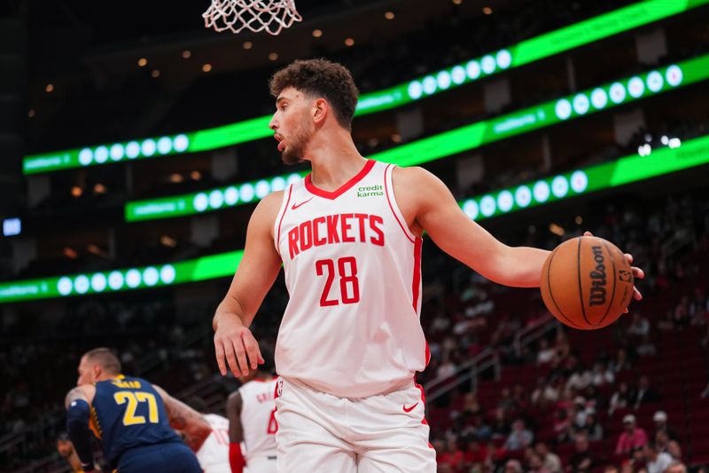 HOUSTON, TEXAS - OCTOBER 10: Alperen Sengun #28 of the Houston Rockets grabs a rebound during the first half of the preseason game against the Indiana Pacers at Toyota Center on October 10, 2023 in Houston, Texas. NOTE TO USER: User expressly acknowledges and agrees that, by downloading and or using this photograph, User is consenting to the terms and conditions of the Getty Images License Agreement. (Photo by Alex Bierens de Haan/Getty Images)