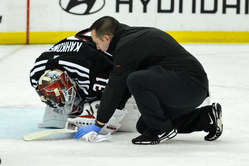 Apr 7, 2024; Newark, New Jersey, USA; New Jersey Devils goaltender Kaapo Kahkonen (31) receives medical attention after an injury during the first period against the Nashville Predators at Prudential Center. Mandatory Credit: John Jones-USA TODAY Sports