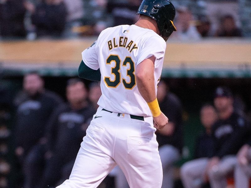 May 21, 2024; Oakland, California, USA; Oakland Athletics outfielder JJ Bleday (33) scores on a wild pitch sixth inning against the Colorado Rockies at Oakland-Alameda County Coliseum. Mandatory Credit: Ed Szczepanski-USA TODAY Sports