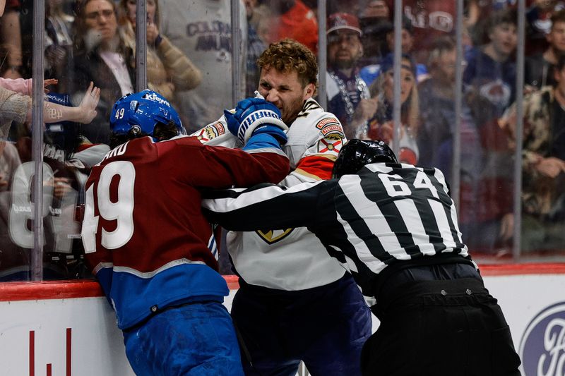 Jan 6, 2024; Denver, Colorado, USA; Florida Panthers left wing Matthew Tkachuk (19) and Colorado Avalanche defenseman Samuel Girard (49) fight as linesman Brandon Gawryletz (64) attempts to separate them in the second period at Ball Arena. Mandatory Credit: Isaiah J. Downing-USA TODAY Sports