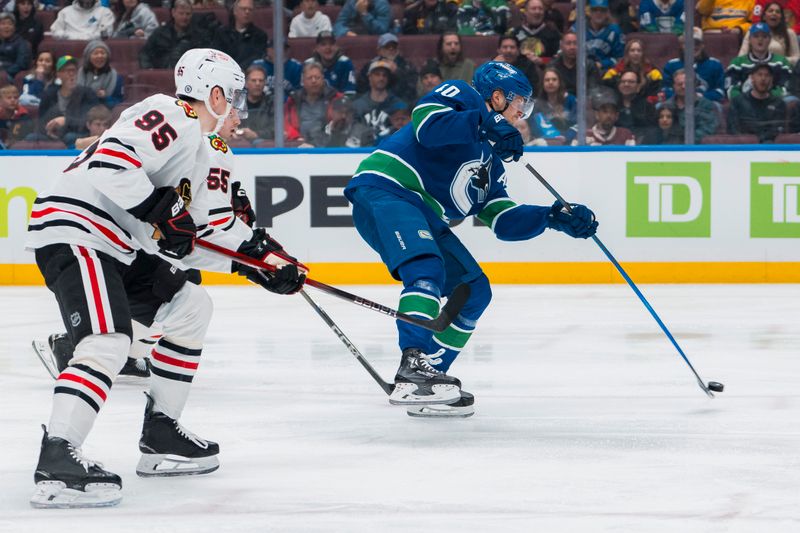 Mar 15, 2025; Vancouver, British Columbia, CAN; Chicago Blackhawks forward Ilya Mikheyev (95) watches as Vancouver Canucks forward Elias Pettersson (40) scores on this shot in the third period at Rogers Arena. Mandatory Credit: Bob Frid-Imagn Images