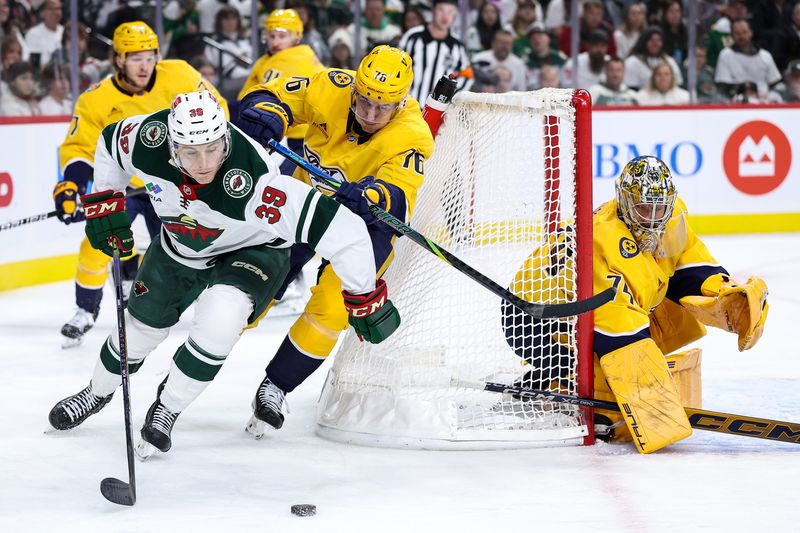 Nov 30, 2024; Saint Paul, Minnesota, USA;Minnesota Wild right wing Ryan Hartman (38) and Nashville Predators defenseman Brady Skjei (76) compete for the puck as goaltender Juuse Saros (74) defends his goal during the second period at Xcel Energy Center. Mandatory Credit: Matt Krohn-Imagn Images