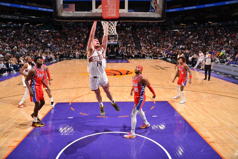 PHOENIX, AZ - MARCH 20:  Drew Eubanks #14 of the Phoenix Suns drives to the basket during the game against the Philadelphia 76ers on March 20, 2024 at Footprint Center in Phoenix, Arizona. NOTE TO USER: User expressly acknowledges and agrees that, by downloading and or using this photograph, user is consenting to the terms and conditions of the Getty Images License Agreement. Mandatory Copyright Notice: Copyright 2024 NBAE (Photo by Barry Gossage/NBAE via Getty Images)