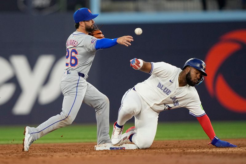 Sep 10, 2024; Toronto, Ontario, CAN; New York Mets second baseman Eddy Alvarez (26) gets Toronto Blue Jays first baseman Vladimir Guerrero Jr. (27) out at second base on a force play during the first inning at Rogers Centre. Mandatory Credit: John E. Sokolowski-Imagn Images