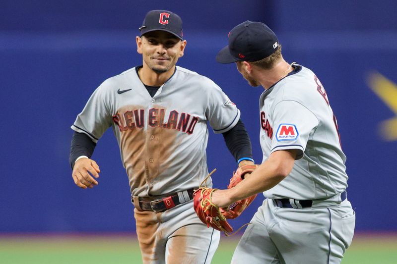 Aug 13, 2023; St. Petersburg, Florida, USA;  Cleveland Guardians starting pitcher Tanner Bibee (61) congratulates second baseman Andres Gimenez (0) after a play against the Tampa Bay Rays in the seventh inning at Tropicana Field. Mandatory Credit: Nathan Ray Seebeck-USA TODAY Sports