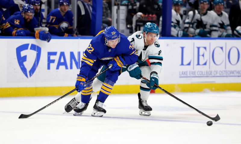 Mar 4, 2025; Buffalo, New York, USA;  Buffalo Sabres right wing Jack Quinn (22) and San Jose Sharks center Nico Sturm (7) go after a loose puck during the third period at KeyBank Center. Mandatory Credit: Timothy T. Ludwig-Imagn Images