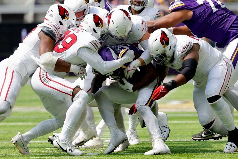 Minnesota Vikings running back DeWayne McBride, center, is stopped by a host of Arizona Cardinals defenders during the second half of an NFL preseason football game, Saturday, Aug. 26, 2023, in Minneapolis. (AP Photo/Bruce Kluckhohn)