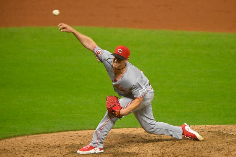 Sep 25, 2024; Cleveland, Ohio, USA; Cincinnati Reds relief pitcher Emilio Pagan (15) delivers a pitch in the eighth inning against the Cleveland Guardians at Progressive Field. Mandatory Credit: David Richard-Imagn Images