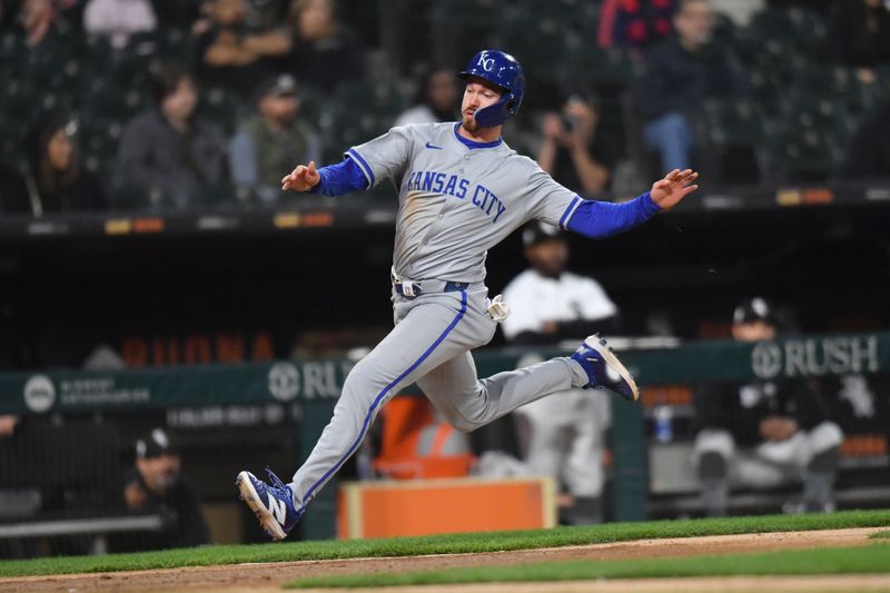 Apr 15, 2024; Chicago, Illinois, USA; Kansas City Royals designated hitter Nick Loftin (12) slides in to score during the fifth inning against the Chicago White Sox at Guaranteed Rate Field. Mandatory Credit: Patrick Gorski-USA TODAY Sports