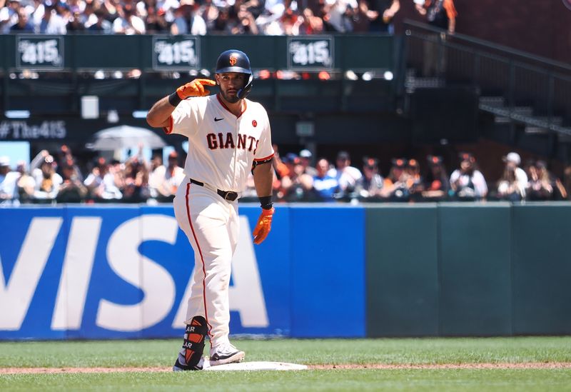 Jun 30, 2024; San Francisco, California, USA; San Francisco Giants first baseman David Villar (32) salutes after hitting an RBI double against the Los Angeles Dodgers during the third inning at Oracle Park. Mandatory Credit: Kelley L Cox-USA TODAY Sports