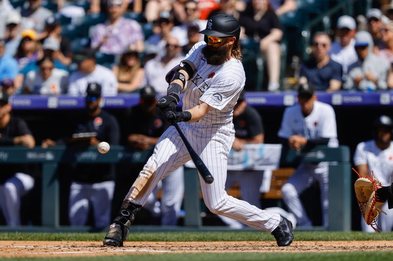 May 27, 2024; Denver, Colorado, USA; Colorado Rockies right fielder Charlie Blackmon (19) hits a three run home run in the fourth inning against the Cleveland Guardians at Coors Field. Mandatory Credit: Isaiah J. Downing-USA TODAY Sports