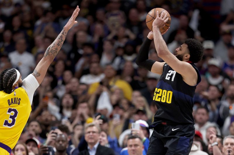 DENVER, COLORADO - APRIL 22: Jamal Murray #27 of the Denver Nuggets puts up a last second shot against Anthony Davis #3 in the fourth quarter to defeat the Los Angeles Lakers during game two of the Western Conference First Round Playoffs at Ball Arena on April 22, 2024 in Denver, Colorado. NOTE TO USER: User expressly acknowledges and agrees that, by downloading and or using this photograph, User is consenting to the terms and conditions of the Getty Images License Agreement. (Photo by Matthew Stockman/Getty Images)