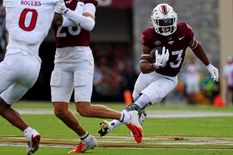 Sep 21, 2024; Blacksburg, Virginia, USA; Virginia Tech Hokies running back Bhayshul Tuten (33) runs for a touchdown during the second quarter against the Rutgers Scarlet Knights at Lane Stadium. Mandatory Credit: Peter Casey-Imagn Images