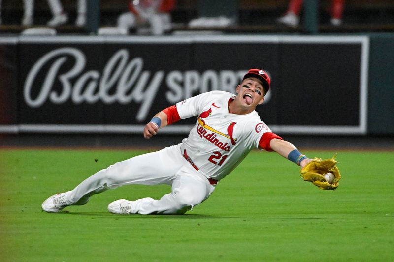 Aug 20, 2024; St. Louis, Missouri, USA;  St. Louis Cardinals right fielder Lars Nootbaar (21) dives and catches a fly ball against the Milwaukee Brewers during the seventh inning at Busch Stadium. Mandatory Credit: Jeff Curry-USA TODAY Sports