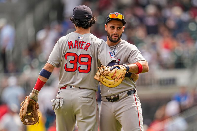 Jun 1, 2025; Cumberland, Georgia, USA; Boston Red Sox third baseman Marcelo Mayer (39) reacts first baseman Abraham Toro (29) after defeating the Atlanta Braves during the at Truist Park. Mandatory Credit: Dale Zanine-Imagn Images