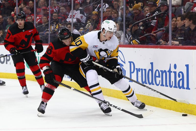 Mar 19, 2024; Newark, New Jersey, USA; Pittsburgh Penguins left wing Drew O'Connor (10) plays the puck while being defended by New Jersey Devils left wing Erik Haula (56) during the third period at Prudential Center. Mandatory Credit: Ed Mulholland-USA TODAY Sports