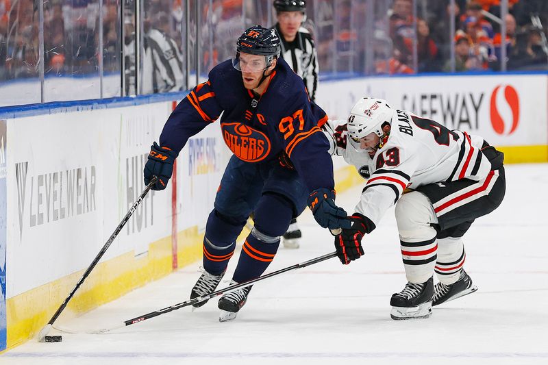 Jan 25, 2024; Edmonton, Alberta, CAN; Edmonton Oilers forward Connor McDavid (97) carries the puck around Chicago Blackhawks forward Colin Blackwell (43) during the first period at Rogers Place. Mandatory Credit: Perry Nelson-USA TODAY Sports