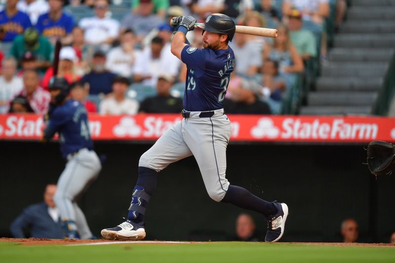 Jul 11, 2024; Anaheim, California, USA; Seattle Mariners catcher Cal Raleigh (29) hits a single against the Los Angeles Angels during the first inning at Angel Stadium. Mandatory Credit: Gary A. Vasquez-USA TODAY Sports