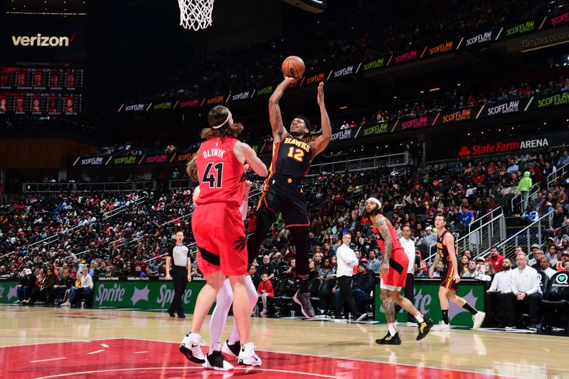 ATLANTA, GA - February 23: De'Andre Hunter #12 of the Atlanta Hawks drives to the basket during the game against the Toronto Raptors on February 23, 2024 at State Farm Arena in Atlanta, Georgia.  NOTE TO USER: User expressly acknowledges and agrees that, by downloading and/or using this Photograph, user is consenting to the terms and conditions of the Getty Images License Agreement. Mandatory Copyright Notice: Copyright 2024 NBAE (Photo by Scott Cunningham/NBAE via Getty Images)