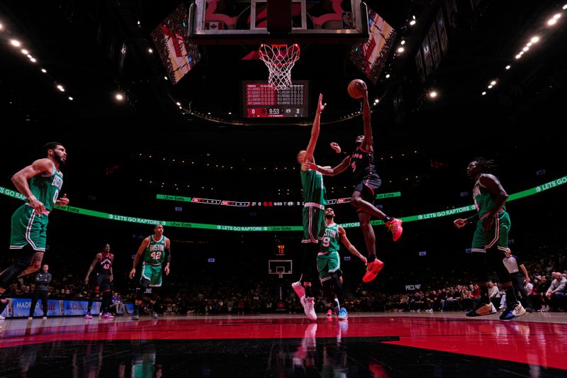 TORONTO, CANADA - JANUARY 15:  Toronto Raptors #5 Immanuel Quickley drives to the basket during the game against the Boston Celtics on January 15, 2024 at the Scotiabank Arena in Toronto, Ontario, Canada.  NOTE TO USER: User expressly acknowledges and agrees that, by downloading and or using this Photograph, user is consenting to the terms and conditions of the Getty Images License Agreement.  Mandatory Copyright Notice: Copyright 2024 NBAE (Photo by Mark Blinch/NBAE via Getty Images)