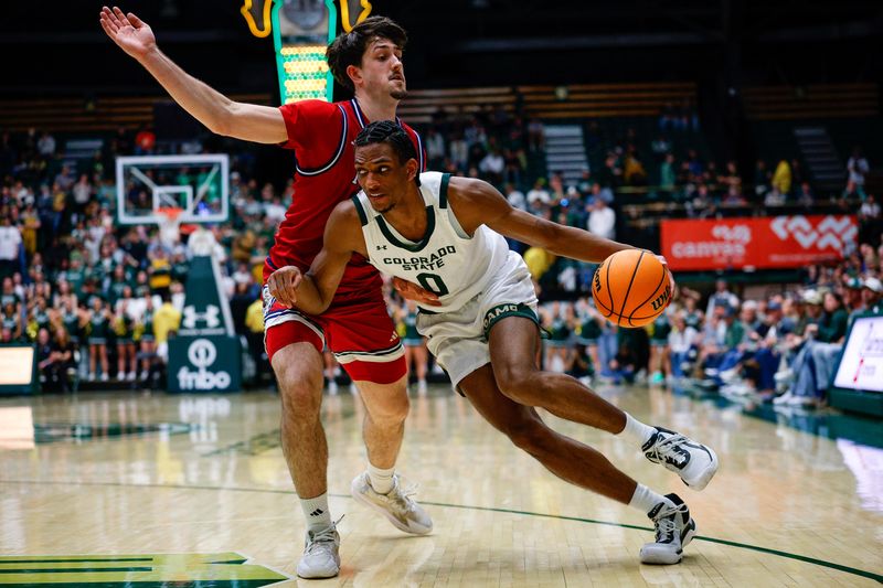 Feb 24, 2026; Fort Collins, Colorado, USA; Colorado State Rams forward Carey Booth (0) controls the ball under pressure from Fresno State Bulldogs guard Cameron Faas (4) in the second half at Moby Arena. Mandatory Credit: Isaiah J. Downing-Imagn Images