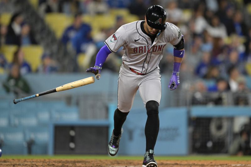 May 20, 2024; Los Angeles, California, USA;  Arizona Diamondbacks left fielder Lourdes Gurriel Jr. (12) hits a solo home run in the eighth inning against the Los Angeles Dodgers at Dodger Stadium. Mandatory Credit: Jayne Kamin-Oncea-USA TODAY Sports