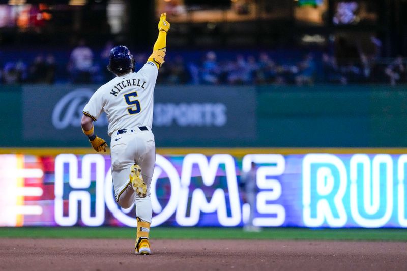 Sep 19, 2024; Milwaukee, Wisconsin, USA;  Milwaukee Brewers designated hitter Garrett Mitchell (5) celebrates after hitting a home run during the seventh inning against the Arizona Diamondbacks at American Family Field. Mandatory Credit: Jeff Hanisch-Imagn Images