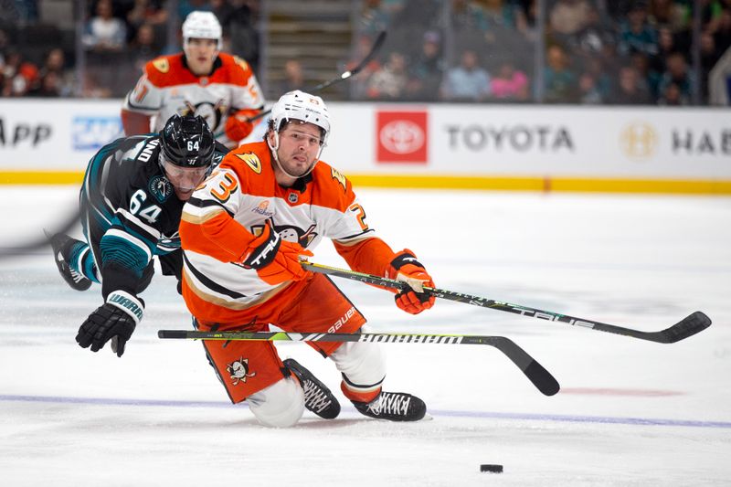 Oct 12, 2024; San Jose, California, USA; San Jose Sharks center Mikael Granlund (64) trips up Anaheim Ducks center Mason McTavish (23) during the second period at SAP Center at San Jose. Mandatory Credit: D. Ross Cameron-Imagn Images