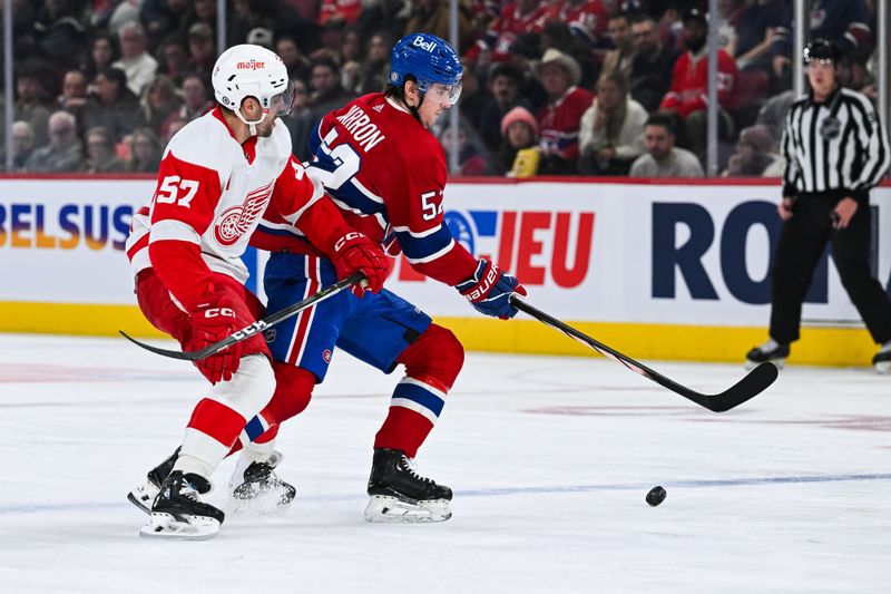 Dec 2, 2023; Montreal, Quebec, CAN; Montreal Canadiens defenseman Justin Barron (52) plays the puck against Detroit Red Wings left wing David Perron (57) during the third period at Bell Centre. Mandatory Credit: David Kirouac-USA TODAY Sports