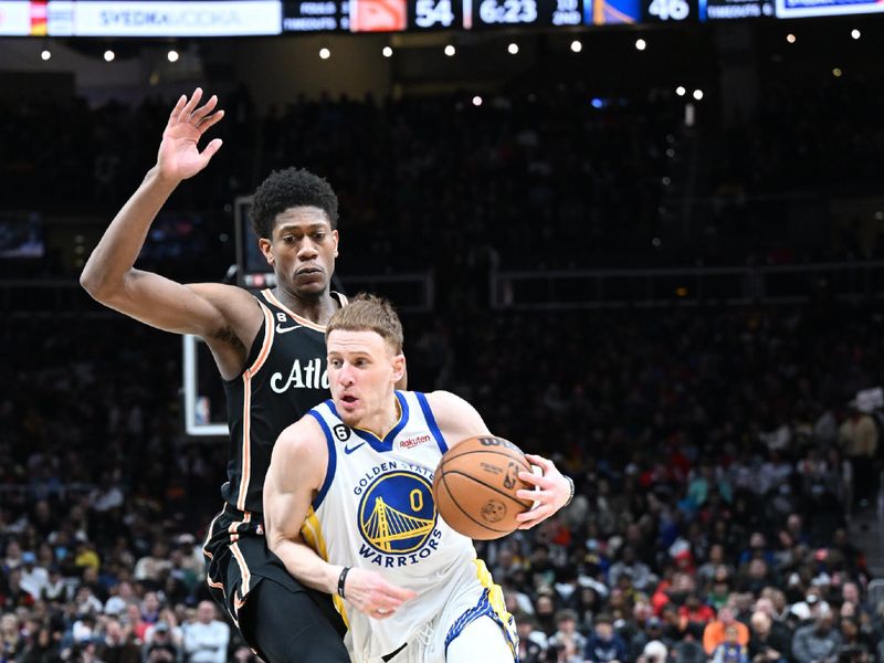 ATLANTA, GA - MARCH 17: Donte DiVincenzo #0 of the Golden State Warriors drives to the basket during the game against the Atlanta Hawks on March 17, 2023 at State Farm Arena in Atlanta, Georgia.  NOTE TO USER: User expressly acknowledges and agrees that, by downloading and/or using this Photograph, user is consenting to the terms and conditions of the Getty Images License Agreement. Mandatory Copyright Notice: Copyright 2023 NBAE (Photo by Adam Hagy/NBAE via Getty Images)