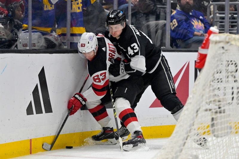 Mar 3, 2024; Los Angeles, California, USA;  New Jersey Devils left wing Jesper Bratt (63) and Los Angeles Kings defenseman Jacob Moverare (43) battle along the boards in the first period at Crypto.com Arena. Mandatory Credit: Jayne Kamin-Oncea-USA TODAY Sports