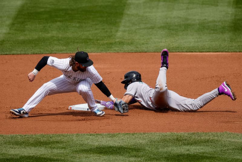 Apr 10, 2024; Denver, Colorado, USA; Arizona Diamondbacks left fielder Lourdes Gurriel Jr. (12) safely steals second against Colorado Rockies second baseman Brendan Rodgers (7) in the first inning at Coors Field. Mandatory Credit: Isaiah J. Downing-USA TODAY Sports