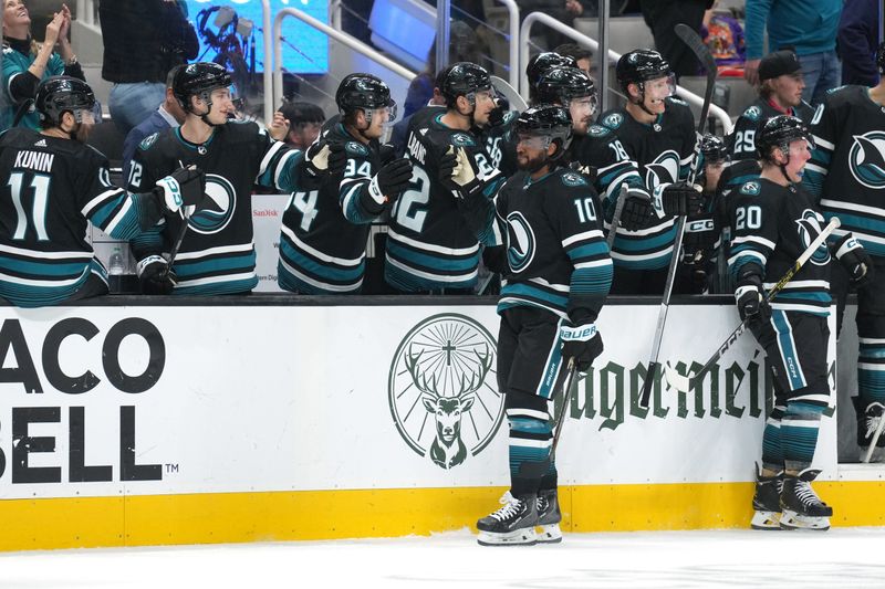 Feb 17, 2024; San Jose, California, USA; San Jose Sharks left wing Anthony Duclair (10) is congratulated by teammates after scoring a goal against the Columbus Blue Jackets during the first period at SAP Center at San Jose. Mandatory Credit: Darren Yamashita-USA TODAY Sports